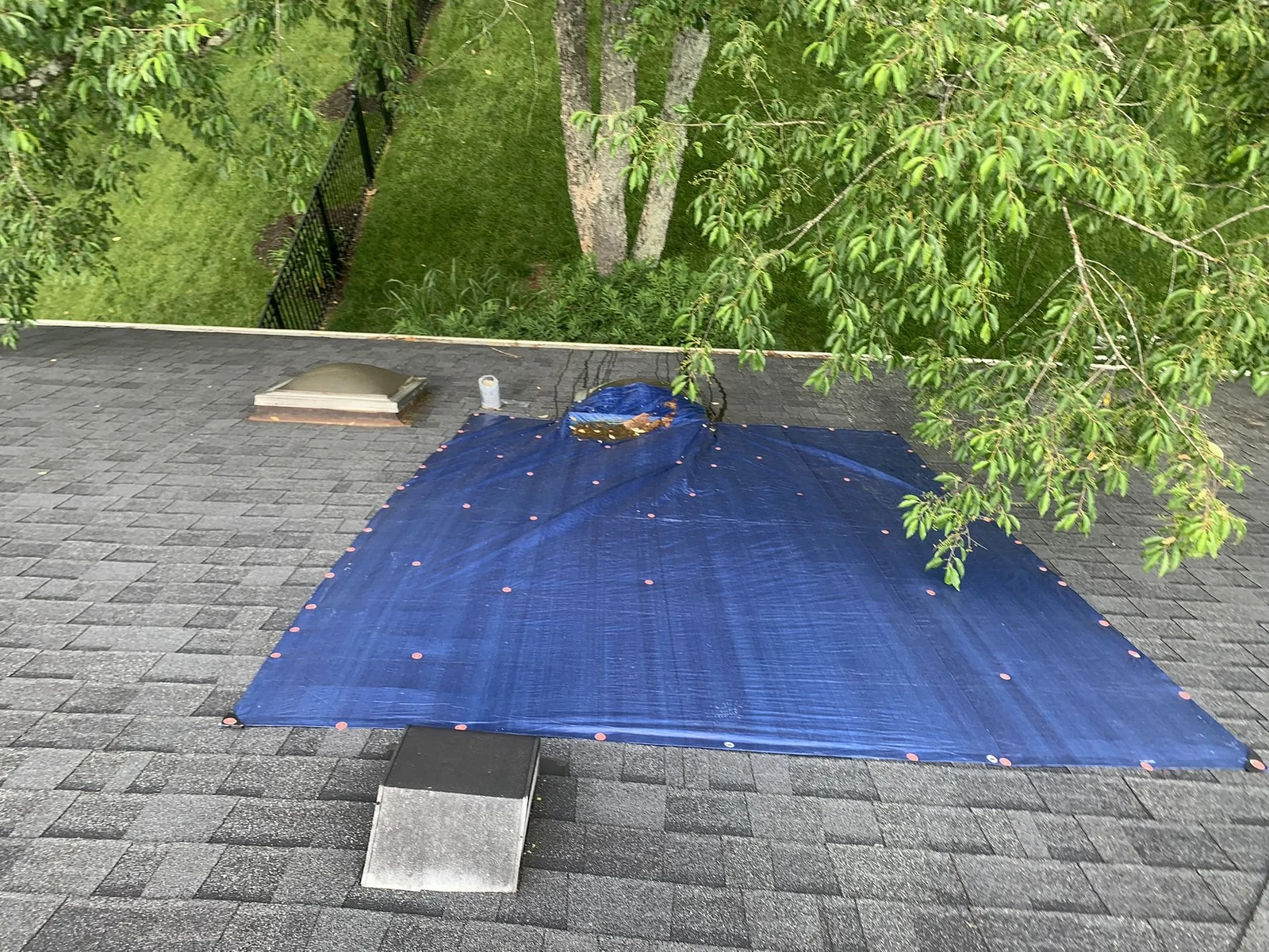 Temporary tarp protecting a roof during an active leak